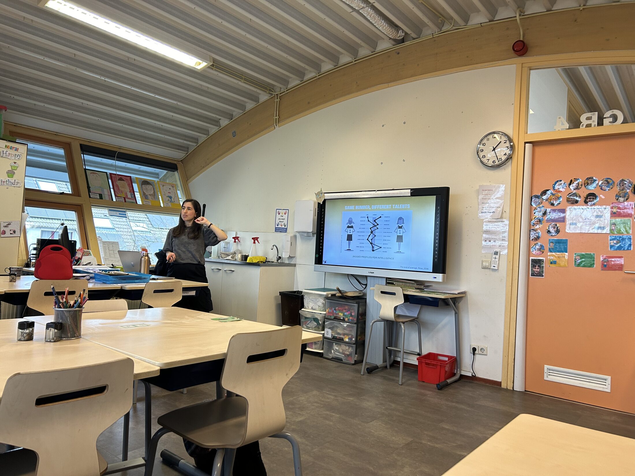 Lihi Engelsman leading a workshop beside a presentation screen