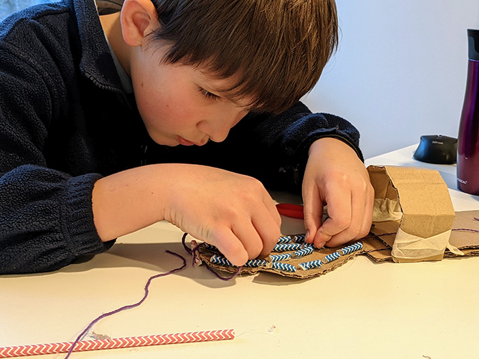 A curious, high achieving boy focused on his science project